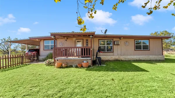 a house view with a sitting space and garden