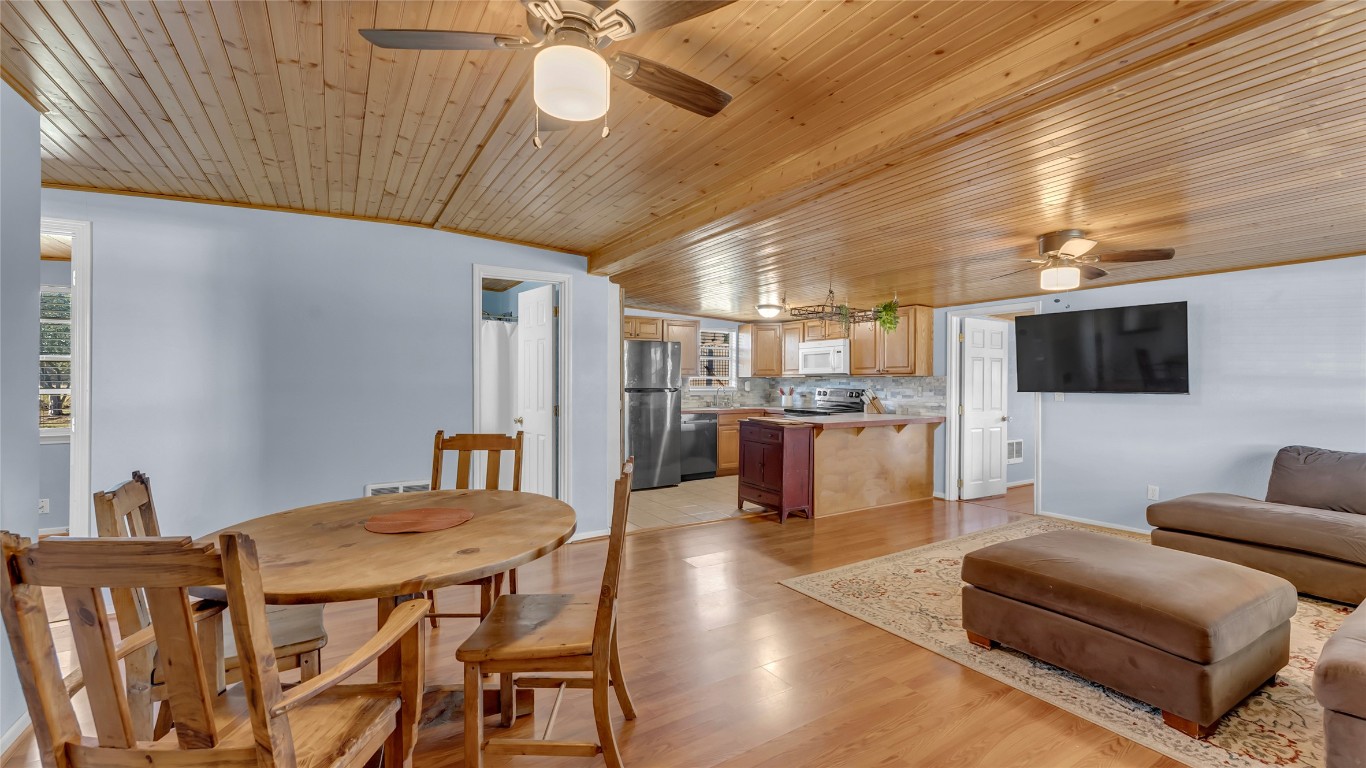 1415 Bee Lane Tow, TX 78672 - Photo 21 of 39 a living room with stainless steel appliances kitchen island granite countertop furniture and a flat screen tv
