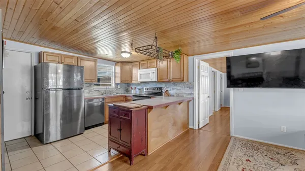 a living room with furniture wooden floor and dining table