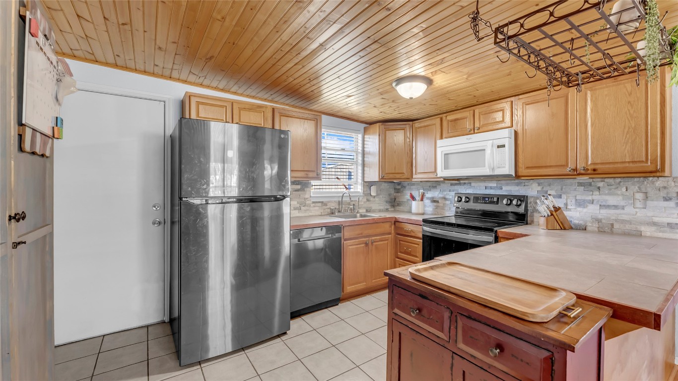 1415 Bee Lane Tow, TX 78672 - Photo 28 of 39 a kitchen with stainless steel appliances granite countertop a refrigerator a sink dishwasher a stove top oven a refrigerator and cabinets