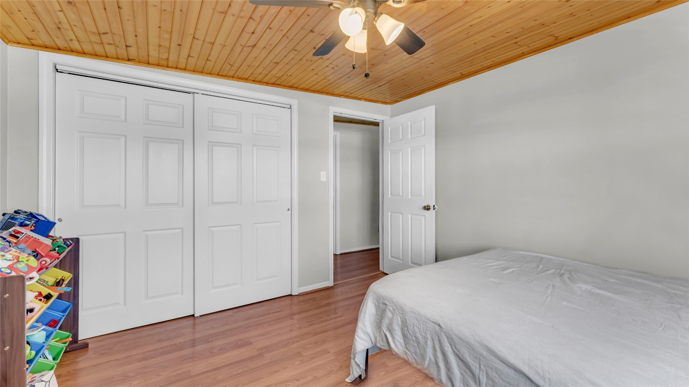 1415 Bee Lane Tow, TX 78672 - Photo 35 of 39 a bedroom with a bed and a chandelier