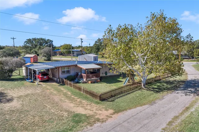 a view of a house with a yard and sitting area
