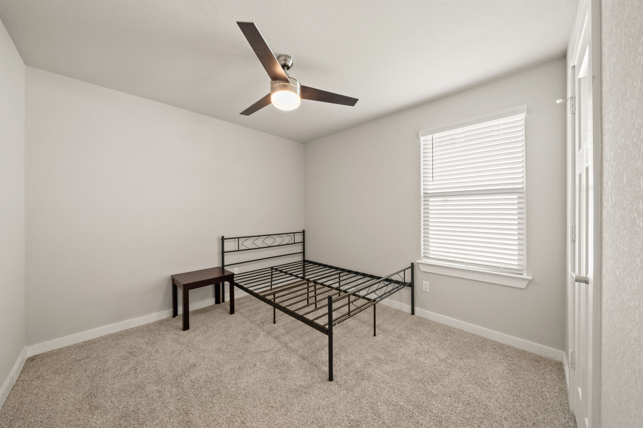 1117 Tipton Street Georgetown, TX 78633 - Photo 34 of 40 Carpeted room featuring a ceiling fan with integrated lighting, a window with blinds, and white trim