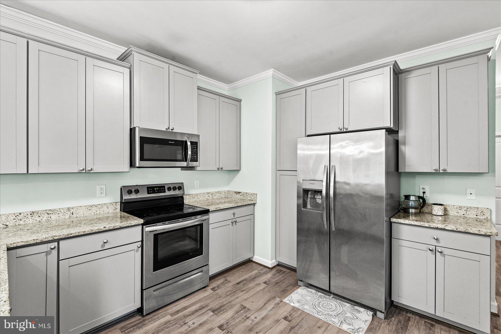 88 Brooks Drive Colonial Beach, VA 22443 - Photo 11 of 36 a kitchen with white cabinets stainless steel appliances and sink