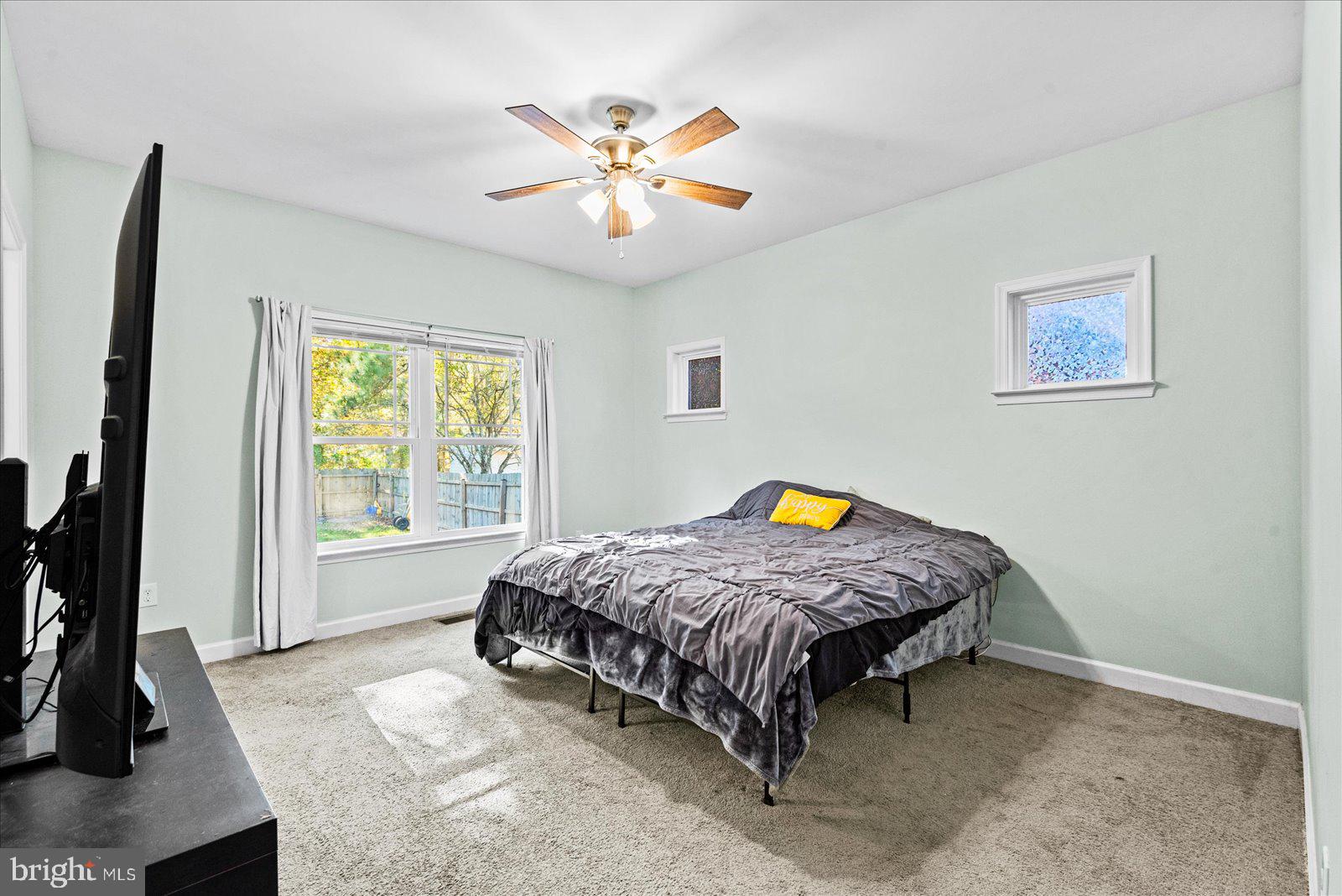 88 Brooks Drive Colonial Beach, VA 22443 - Photo 16 of 36 a bedroom with a bed and a chandelier