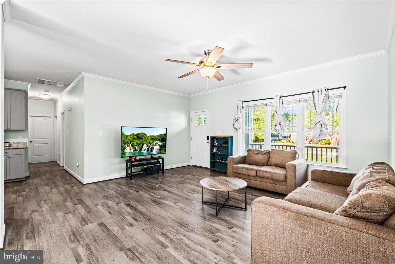 88 Brooks Drive Colonial Beach, VA 22443 - Photo 6 of 36 a living room with furniture ceiling fan and a window