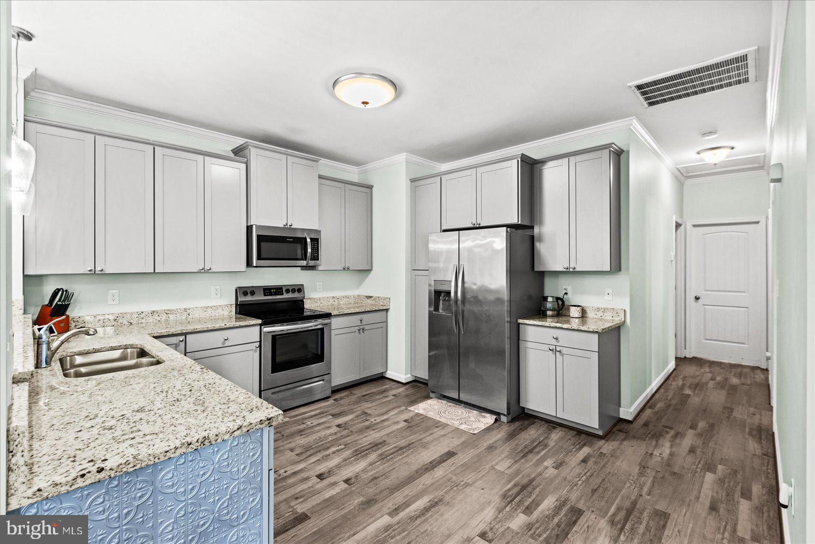 88 Brooks Drive Colonial Beach, VA 22443 - Photo 10 of 36 a kitchen with granite countertop a refrigerator stove and sink