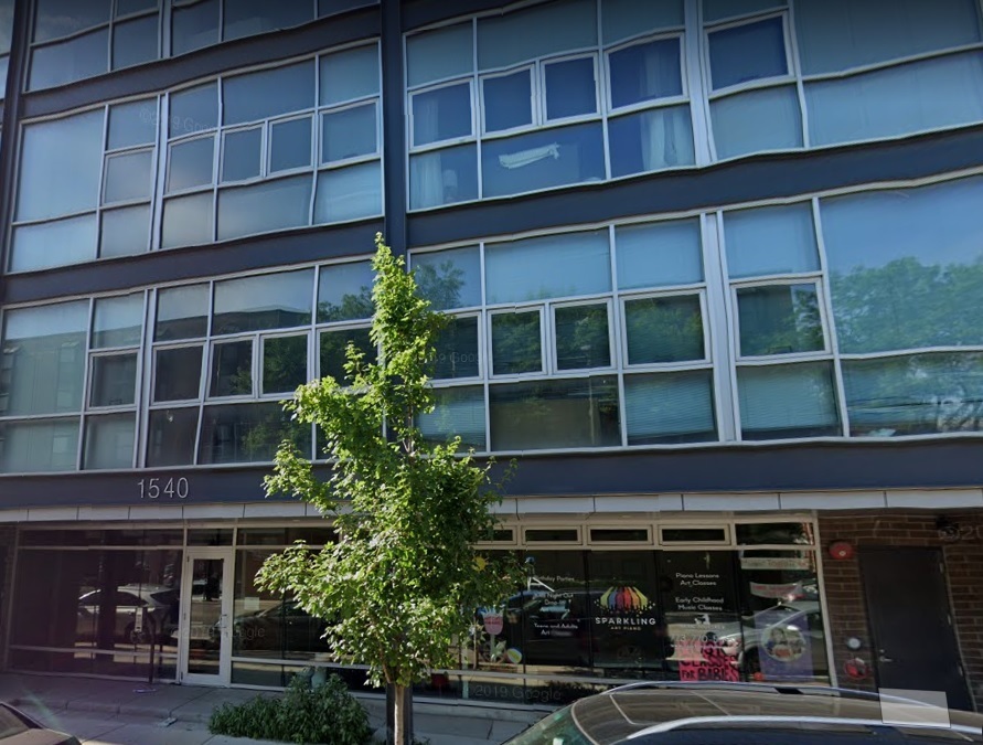 1540 West Fullerton Avenue, Unit 405 Chicago, IL 60614 - Photo 1 of 17 a front view of building with a window and potted plants