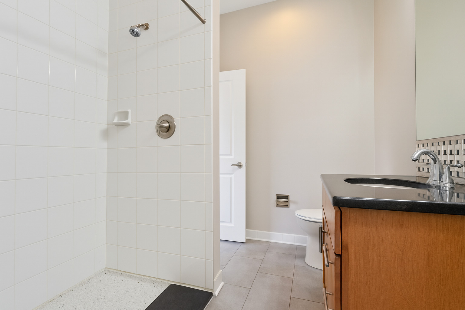 1540 West Fullerton Avenue, Unit 405 Chicago, IL 60614 - Photo 12 of 17 a bathroom with a granite countertop sink a toilet and shower