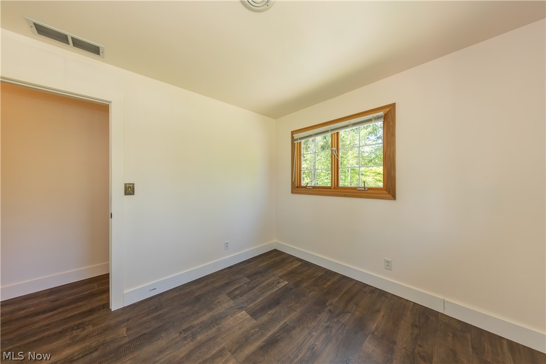 7969 Dines Road Novelty, OH 44072 - Photo 27 of 48 Bedroom featuring wood-finish flooring, white baseboards, and neutral wall paint