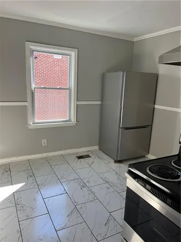 a kitchen with a stove a refrigerator and a sink