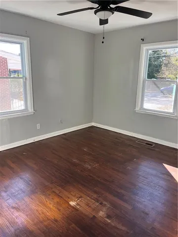 wooden floor in an empty room with a window