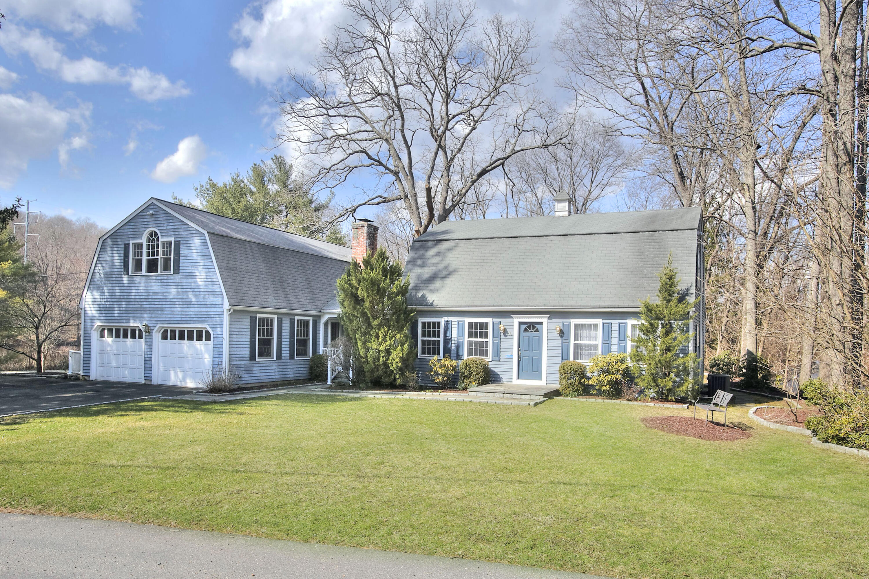 16 Arrowhead Road Wilton, CT 06897 - Photo 1 of 37 a front view of a building with a garden and plants