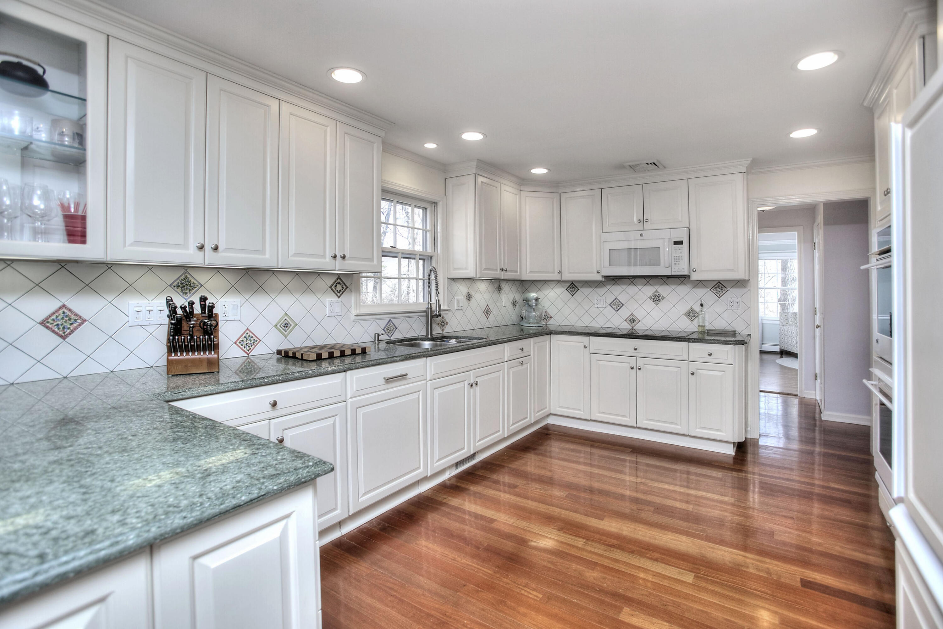 16 Arrowhead Road Wilton, CT 06897 - Photo 2 of 37 a kitchen with granite countertop white cabinets and white stainless steel appliances