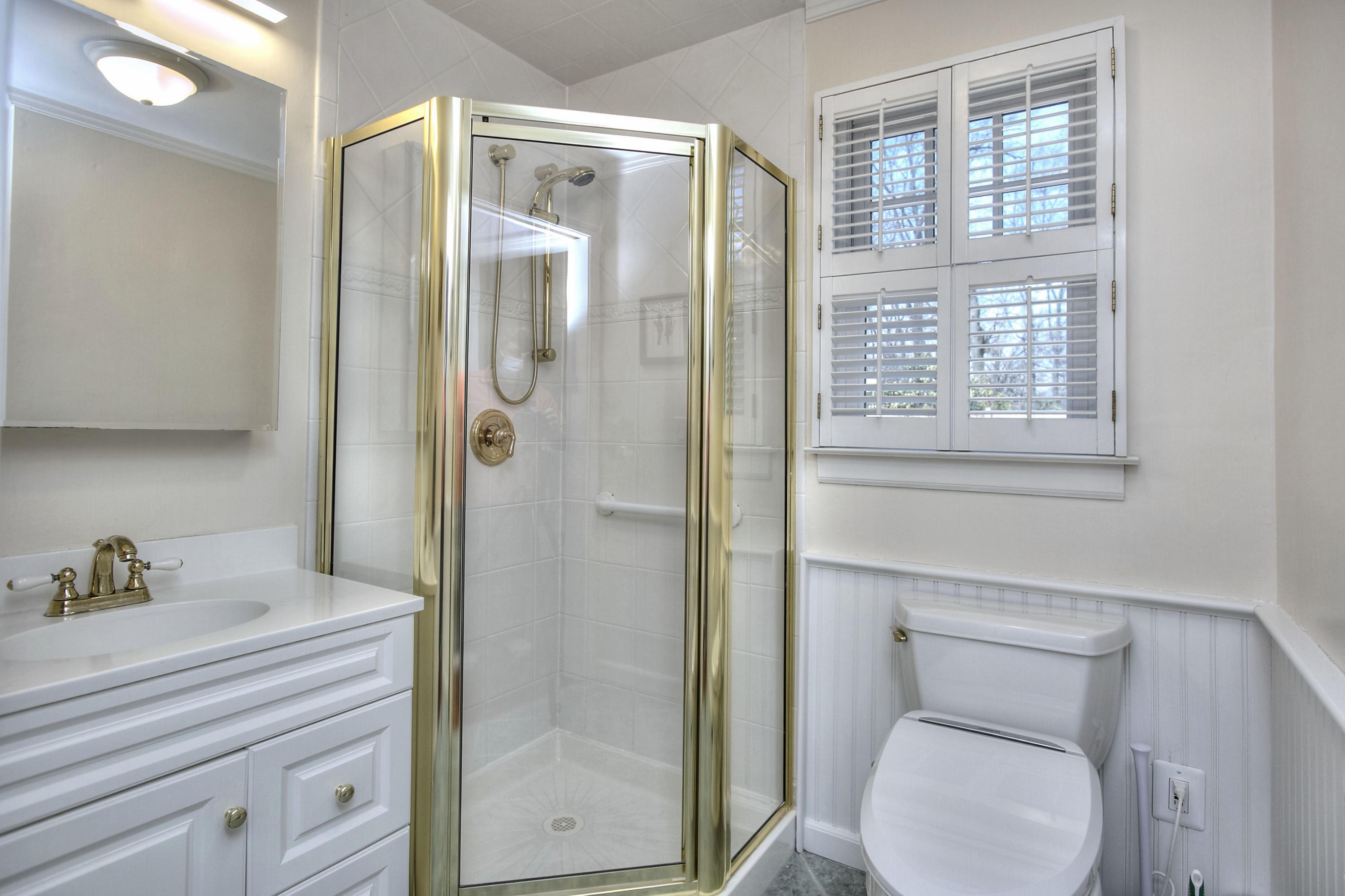 16 Arrowhead Road Wilton, CT 06897 - Photo 12 of 37 a bathroom with a toilet a sink and shower
