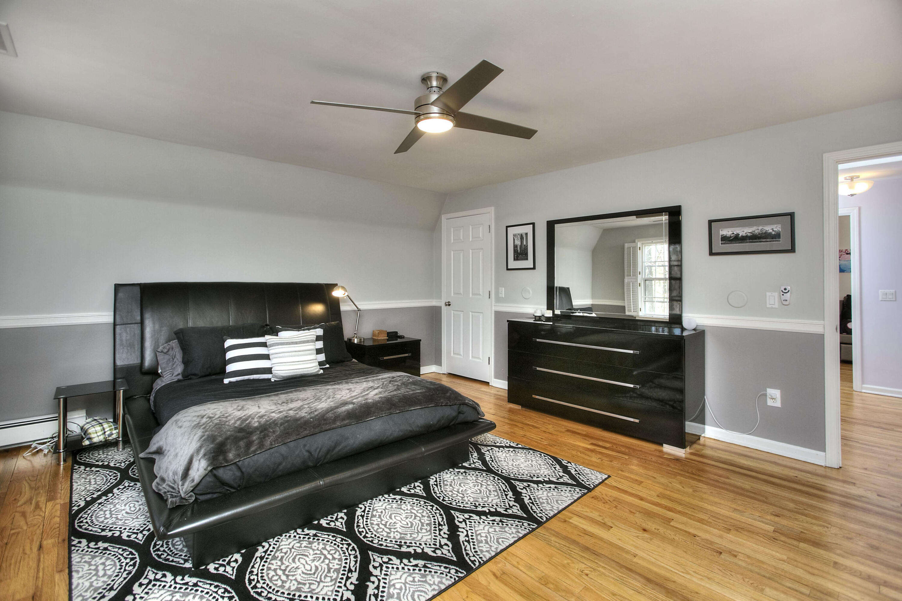 16 Arrowhead Road Wilton, CT 06897 - Photo 13 of 37 a bedroom with a bed and wooden floor
