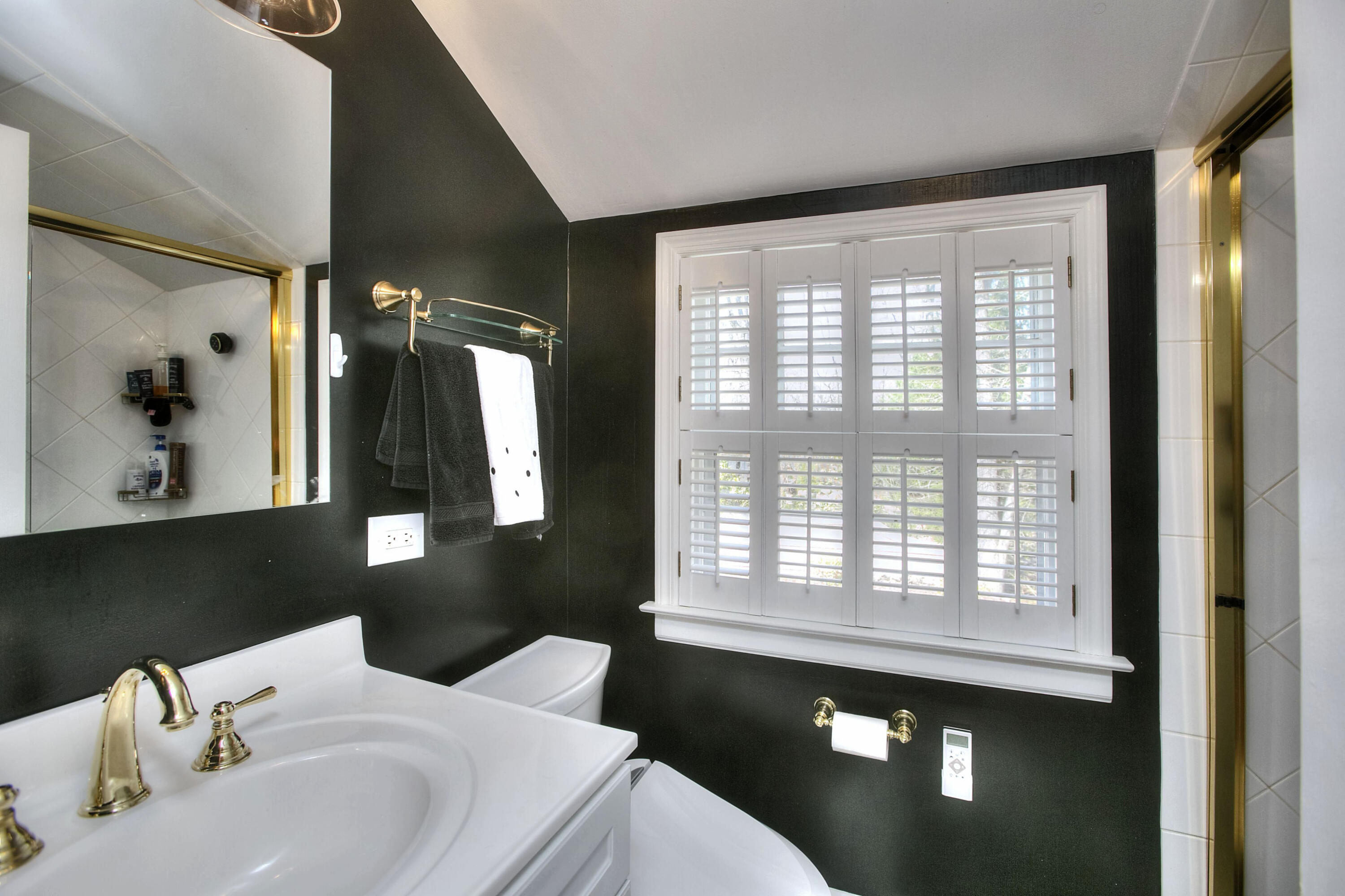 16 Arrowhead Road Wilton, CT 06897 - Photo 14 of 37 a bathroom with a sink and a mirror