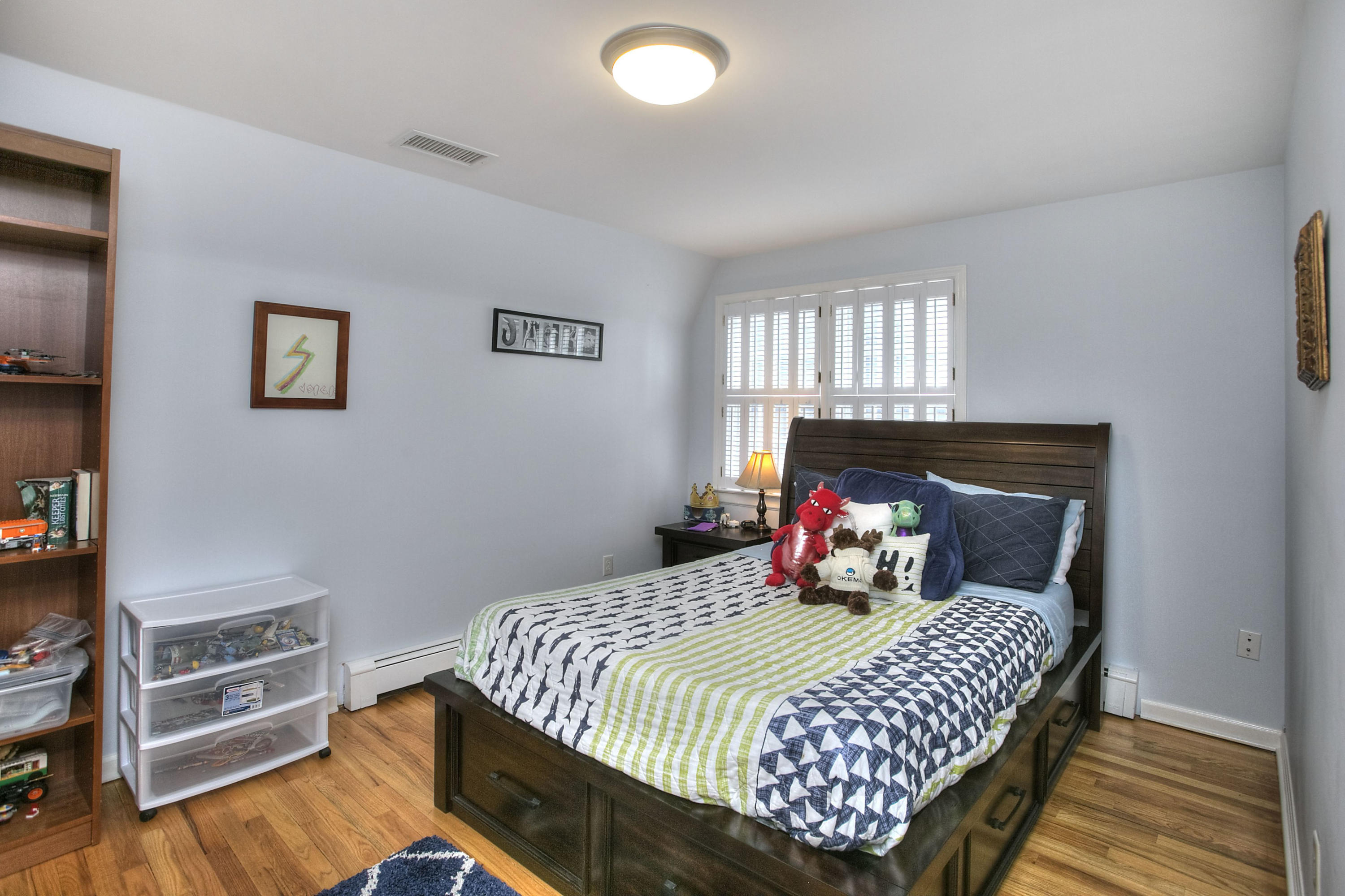 16 Arrowhead Road Wilton, CT 06897 - Photo 17 of 37 a bedroom with a bed and wooden floor