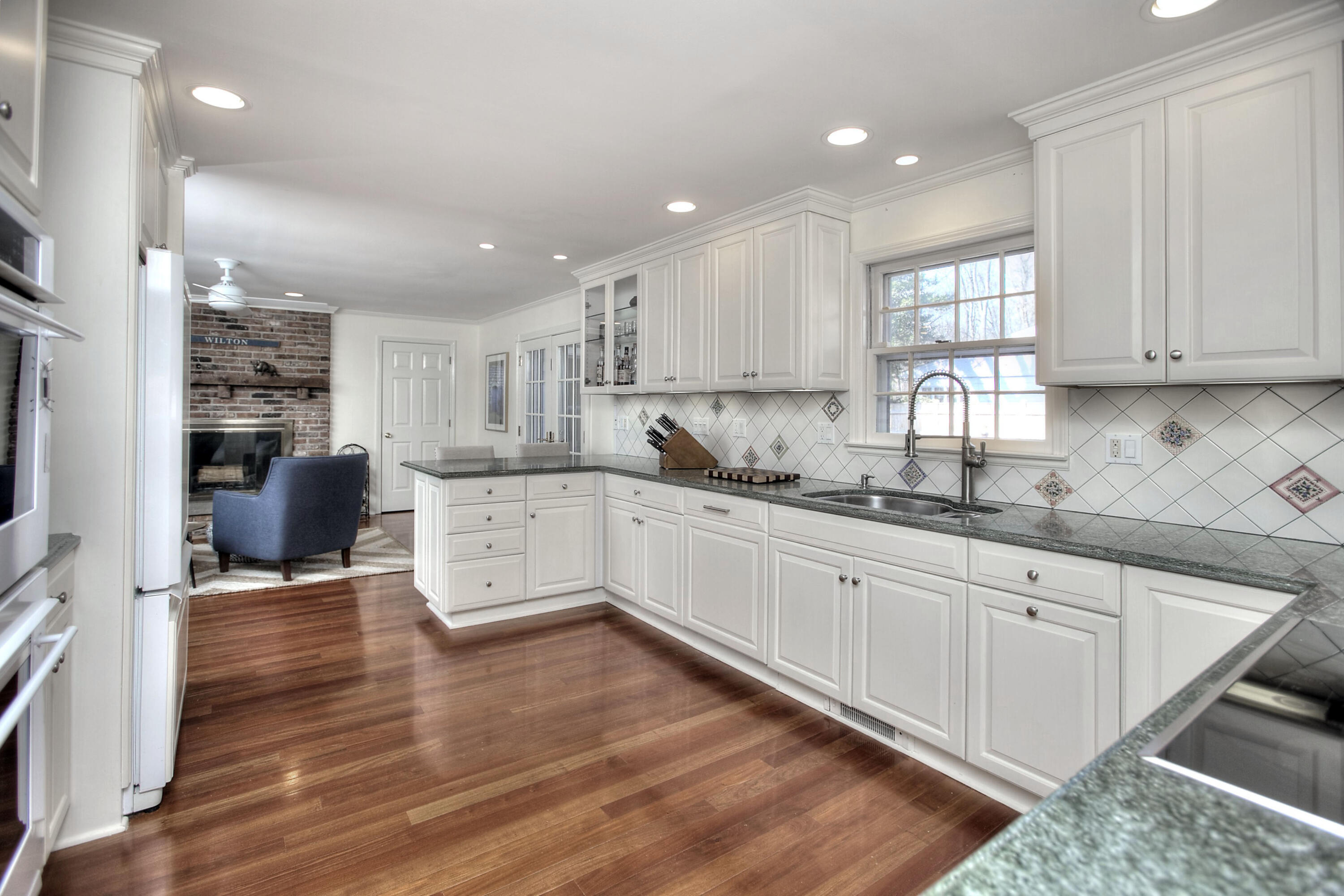 16 Arrowhead Road Wilton, CT 06897 - Photo 3 of 37 a kitchen with granite countertop white cabinets and appliances