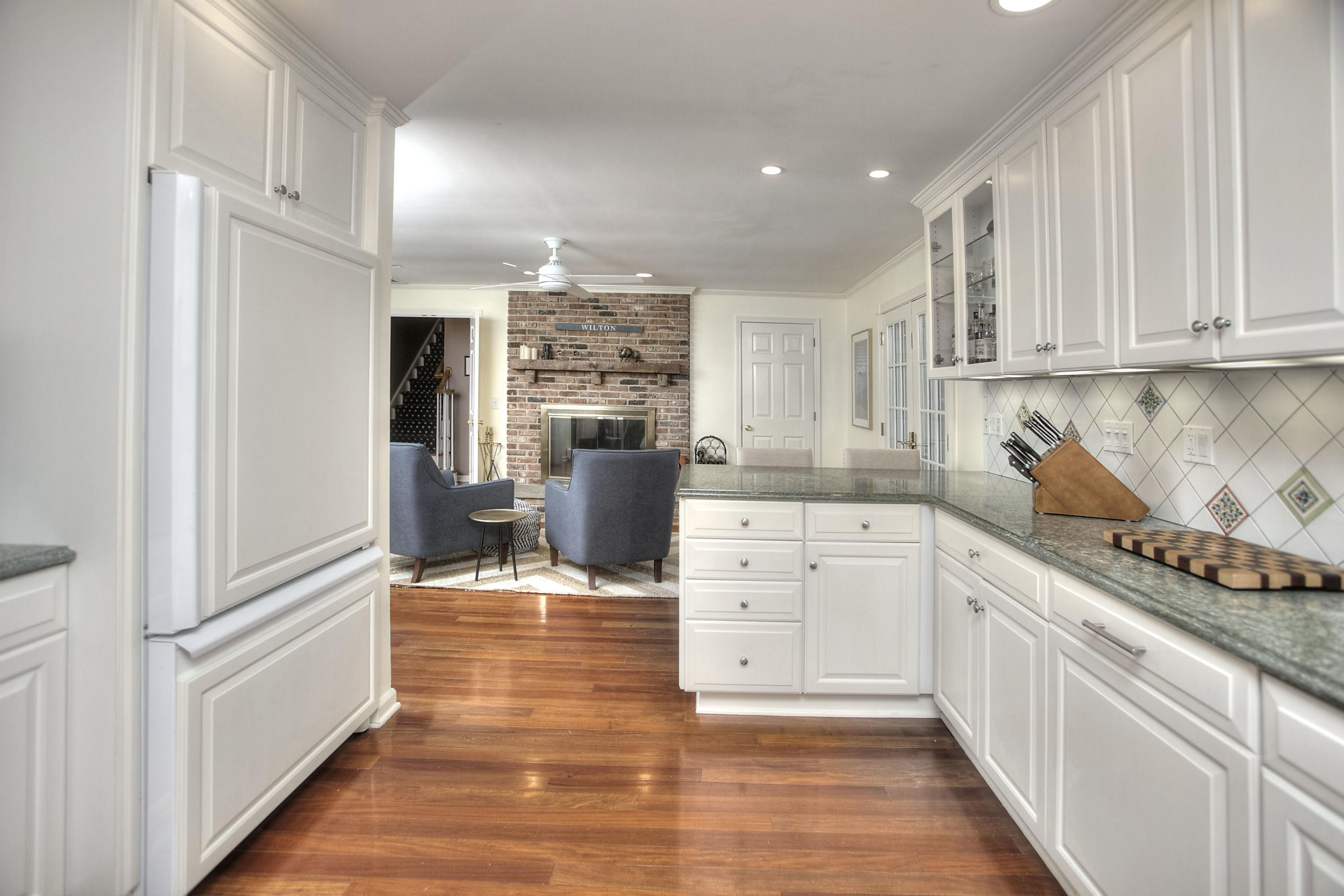 16 Arrowhead Road Wilton, CT 06897 - Photo 4 of 37 a kitchen with granite countertop a refrigerator and a stove top oven