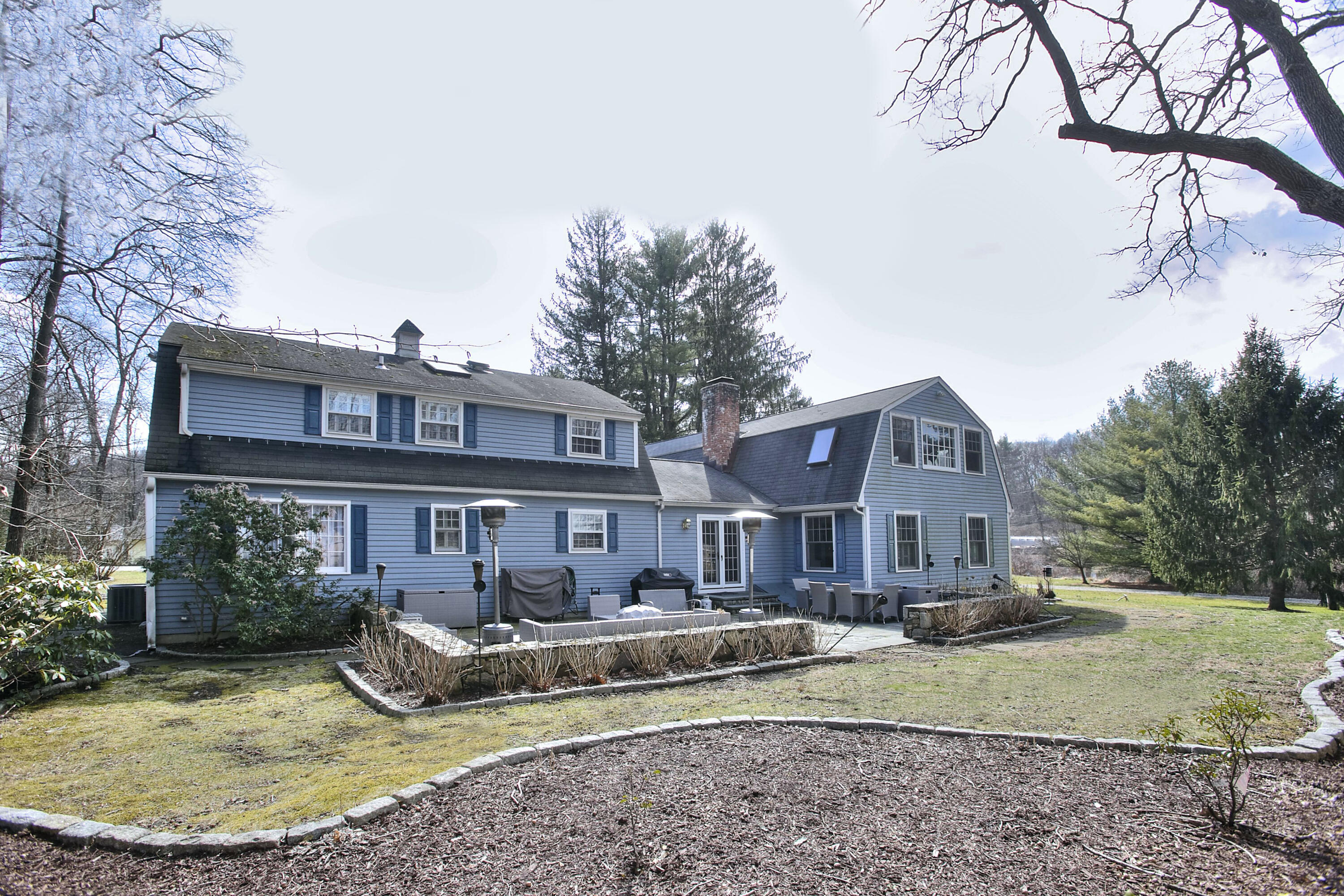 16 Arrowhead Road Wilton, CT 06897 - Photo 34 of 37 a front view of a house with a yard outdoor seating and barbeque oven
