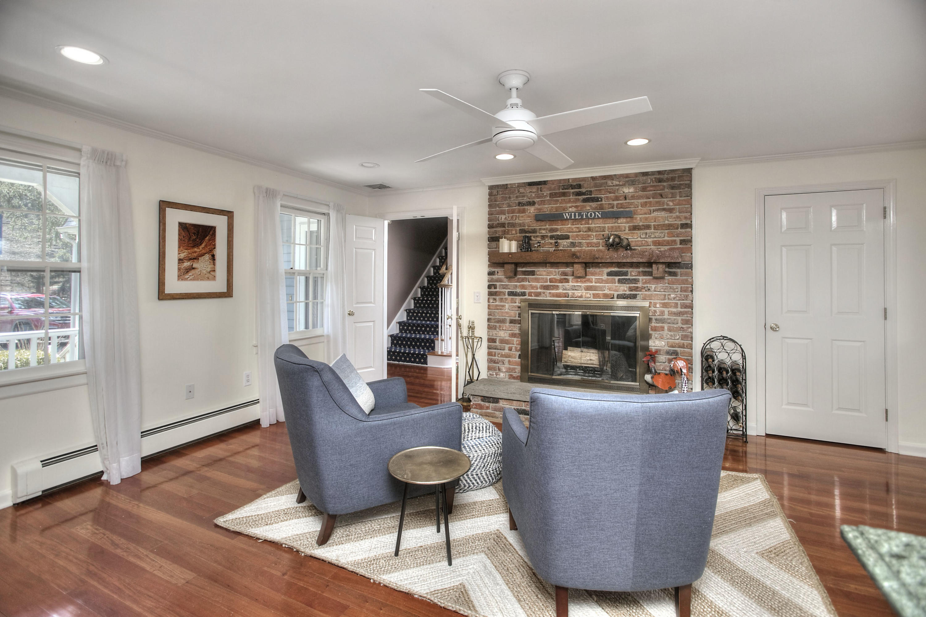 16 Arrowhead Road Wilton, CT 06897 - Photo 6 of 37 a living room with furniture and a fireplace