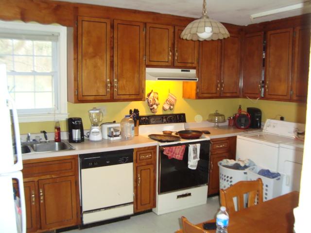 1075 Drake Road Adams, TN 37010 - Photo 3 of 4 a kitchen with stainless steel appliances granite countertop a sink a stove and a refrigerator