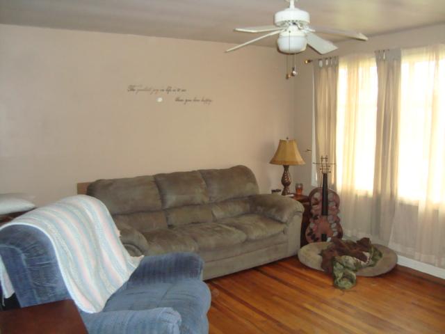 1075 Drake Road Adams, TN 37010 - Photo 4 of 4 a living room with couches painting on the wall and a window