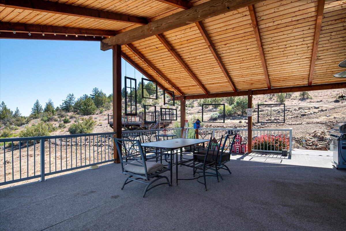 11182 Southwest Dynamite Lane Culver, OR 97734 - Photo 19 of 70 a view of a roof deck with table and chairs