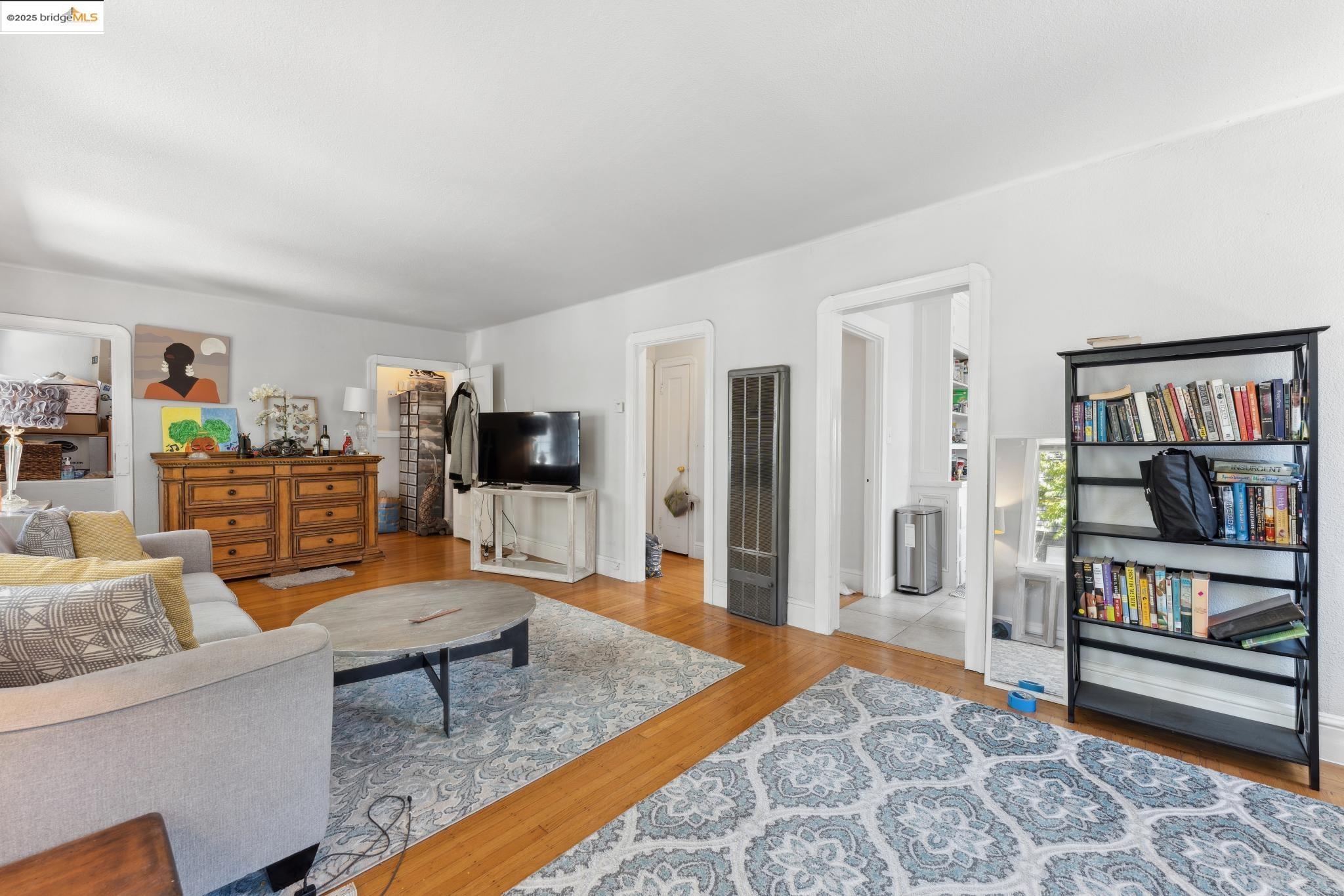 2823 11th Avenue, Unit B Oakland, CA 94610 - Photo 3 of 12 a living room with furniture and a rug