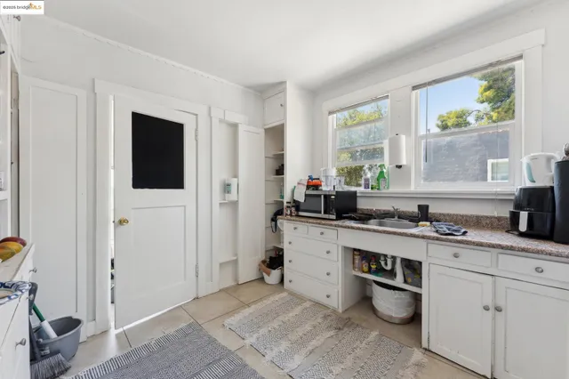 a kitchen with a sink cabinets and window