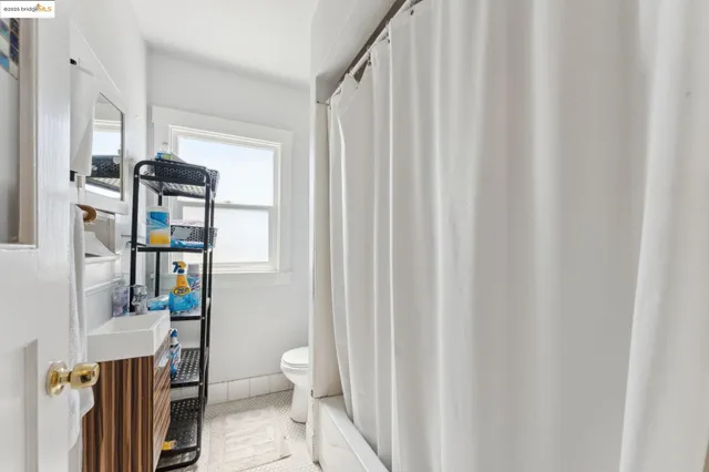 a living room with furniture and a toilet
