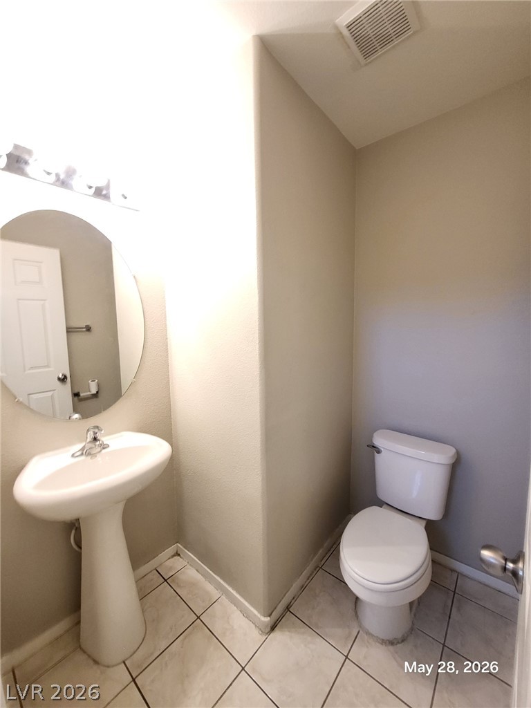 9843 West Overlook Ridge Avenue Las Vegas, NV 89148 - Photo 7 of 19 A well-maintained bathroom featuring a classic pedestal sink and practical tile flooring.