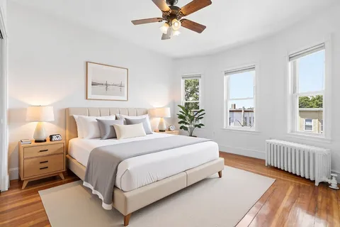 a bedroom with a bed and a window