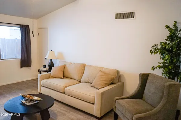 a living room with furniture and a potted plant