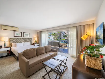 a living room with furniture and a potted plant
