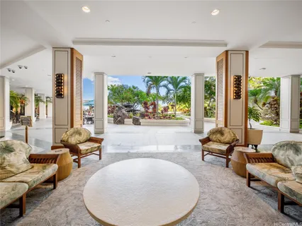 a living room with furniture and large windows