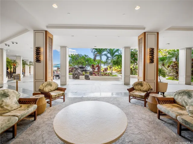 a living room with furniture and large windows