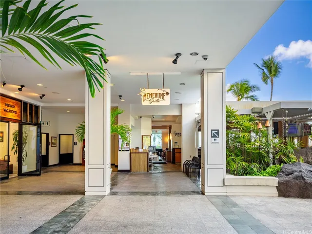 a view of a hallway with potted plants