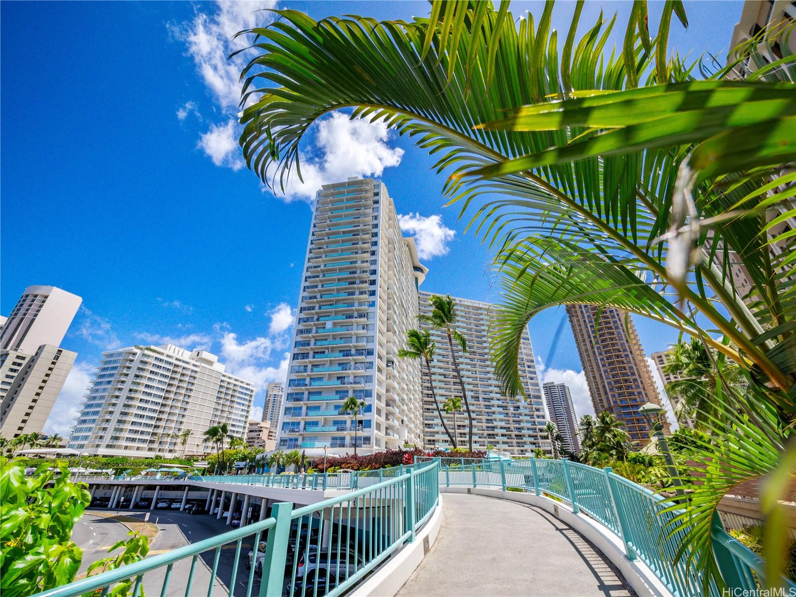 1777 Ala Moana Boulevard, Unit 213 Honolulu, HI 96815 - Photo 20 of 21 a view of a tall building with a palm tree