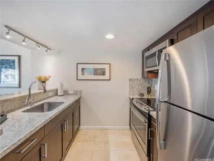 a kitchen with a refrigerator sink and stove