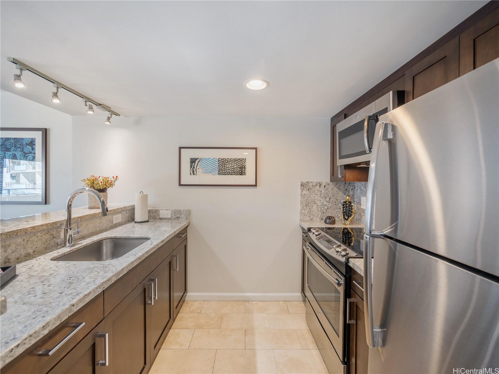 1777 Ala Moana Boulevard, Unit 213 Honolulu, HI 96815 - Photo 4 of 21 a kitchen with a refrigerator sink and stove