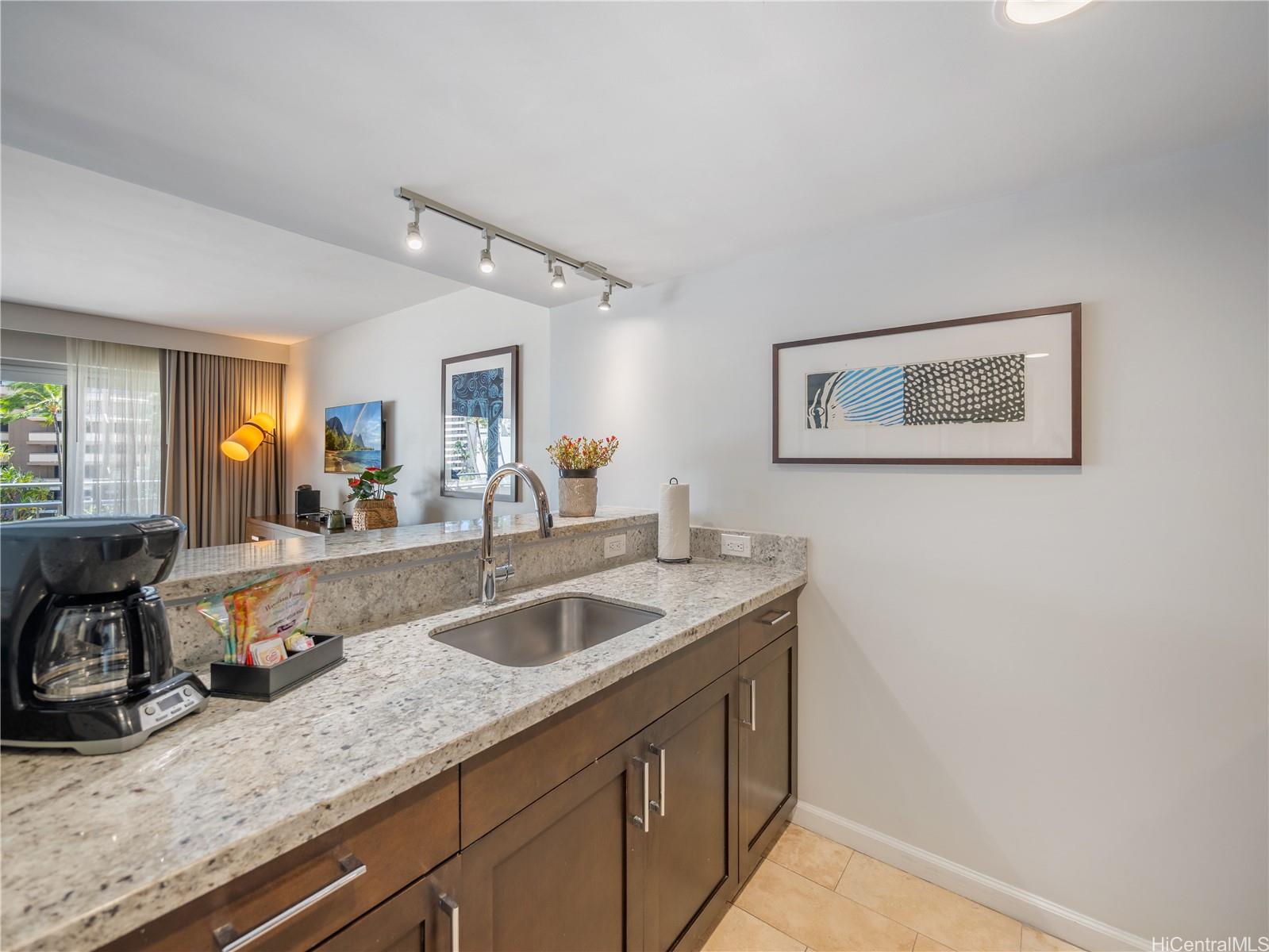 1777 Ala Moana Boulevard, Unit 213 Honolulu, HI 96815 - Photo 5 of 21 a kitchen with a sink and a refrigerator