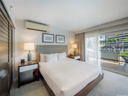 a bedroom with a bed and a night stand