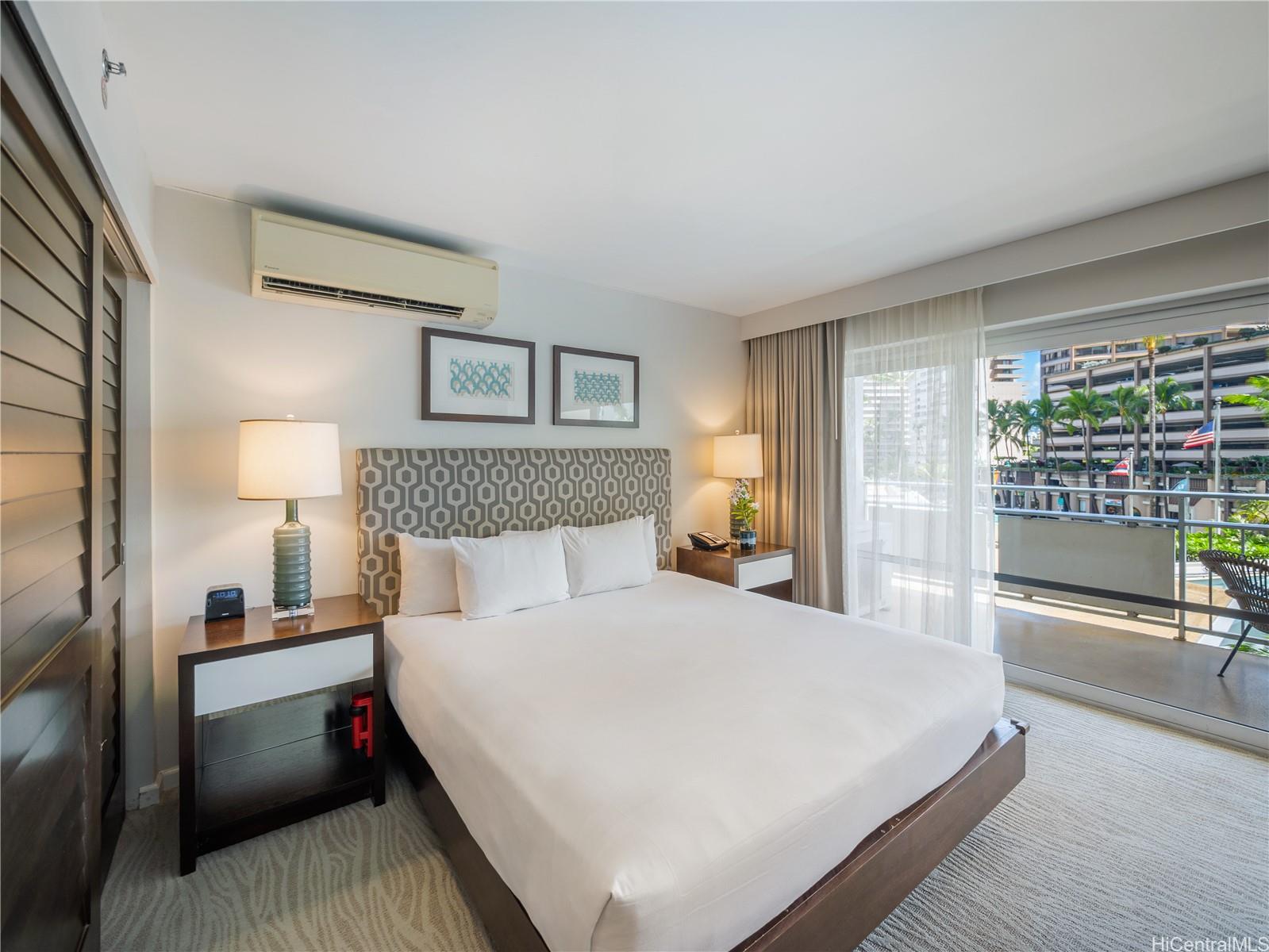 1777 Ala Moana Boulevard, Unit 213 Honolulu, HI 96815 - Photo 6 of 21 a bedroom with a bed and a night stand