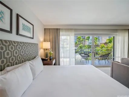 a bedroom with a large bed and a large window