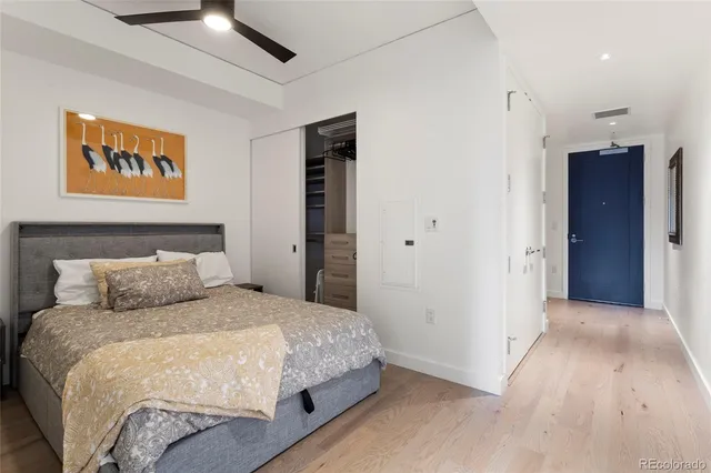 a bedroom with a large bed and a chandelier