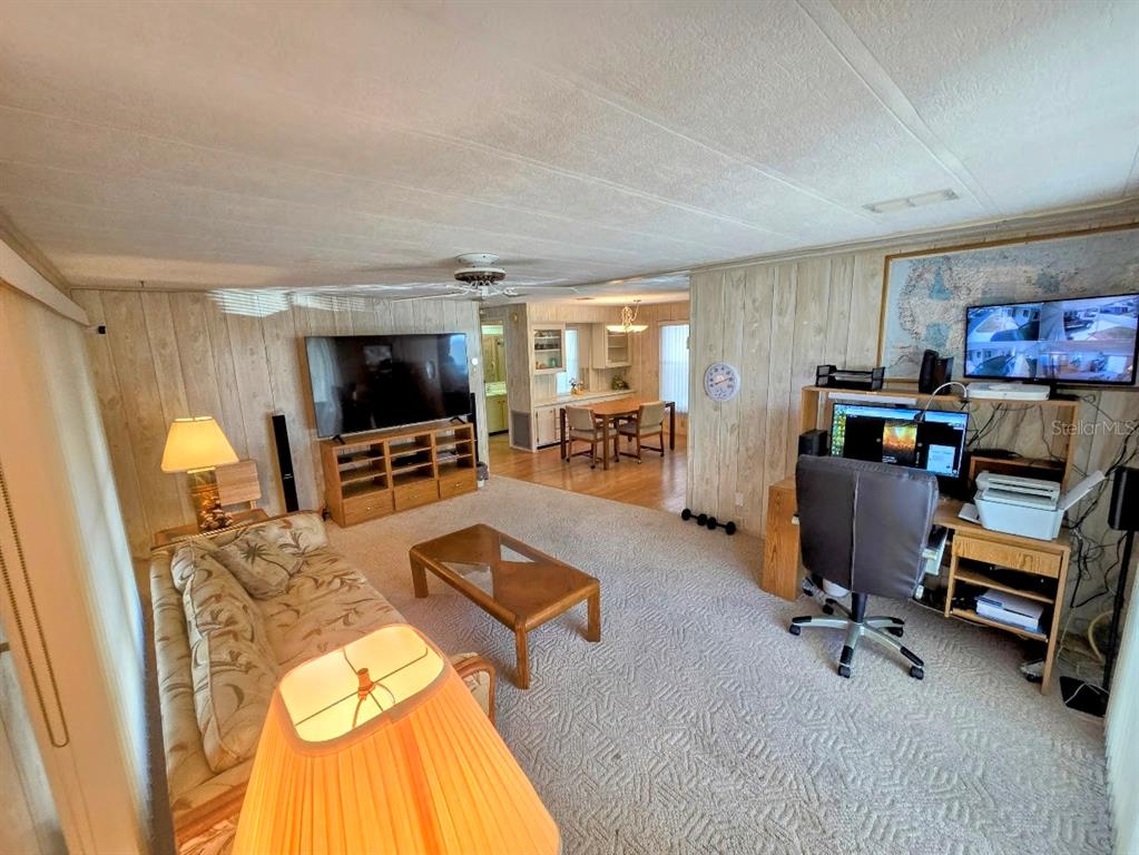 12501 Ulmerton Road, Unit 188 Largo, FL 33774 - Photo 14 of 63 a living room with furniture and a flat screen tv