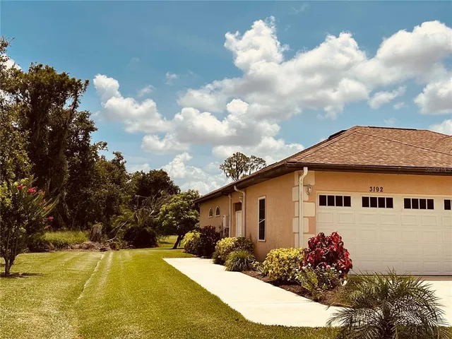 an empty room with chandelier fan and windows