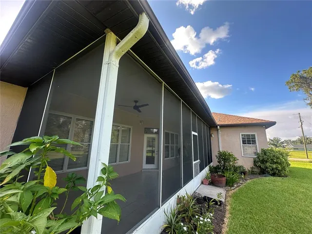 a view of a hallway with wooden floor and entryway